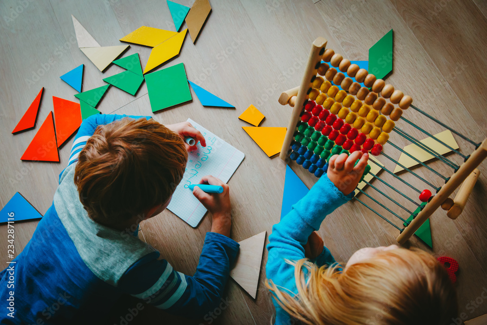 Wall mural little boy and girl learn to write and calculate numbers