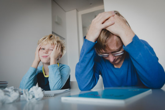 father and son tired of doing homework together
