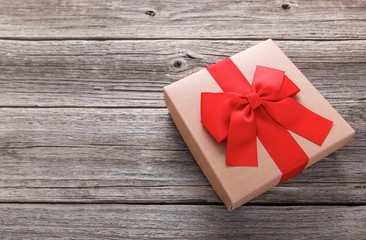 Stylish gift box on the background of wooden boards.