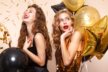 Beautiful young girls in elegant evening dresses with festive balloons. Beauty face.