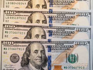 Background with crypto bitcoin and dollars. A symbolic coins of bitcoins on banknotes of one hundred dollars.