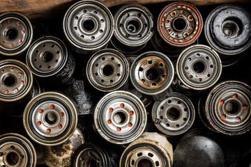 Picture of old car oil filters represented in automobile service center. Old fuel filters of diesel...