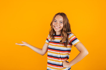 Portrait of a cheerful young girl presenting copy space