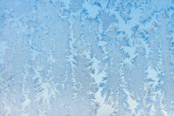 The patterns made by the frost on the window. Frosty winter background photo