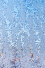 The patterns made by the frost on the window. Frosty winter background photo