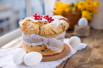 Easter cupcake on the wooden window. Bouquet of spring flowers narcissus. Greeting card for the holiday. Free space for text.