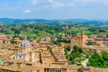 Fototapeta na wymiar Historic town Siena, Tuscany - Aerial view with beautiful landscape scenery on a sunny summer day, walled medieval hill town with towers in the province of Siena, Italy- Europe