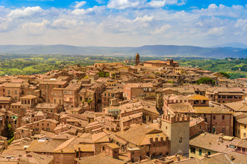Fototapeta na wymiar Historic town Siena, Tuscany - Aerial view with beautiful landscape scenery on a sunny summer day, walled medieval hill town with towers in the province of Siena, Italy- Europe