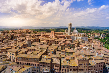 Historic town Siena, Tuscany - Aerial view with beautiful landscape scenery on a sunny summer day, walled medieval hill town with towers in the province of Siena, Italy- Europe