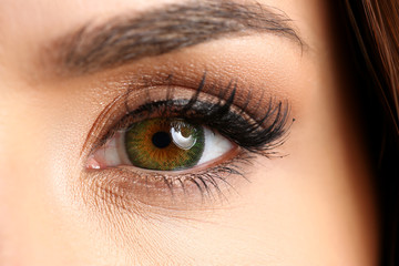 Fototapeta premium Female left emerald green coloured eye extreme closeup