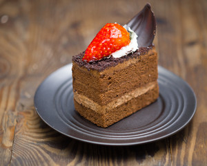 Chocolate cake in saucer on distressed wood