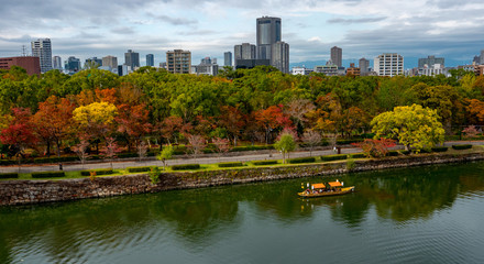 Fototapeta premium Boat cruise at Osaka Castle Complex in autumn season in Osaka, Japan.