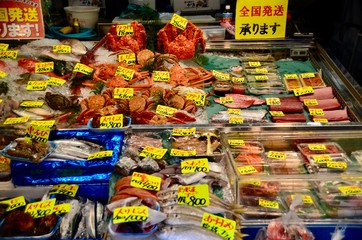 Raw fish and sea food oyster sea shell squid crab and prawn on the ice in Tsukiji Fish market in Tokyo,Japan 