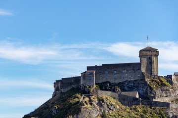 Fototapeta na wymiar The Castle Fort sits atop a high rock outcropping in Lourdes, France