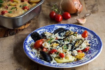 Rice, potatoes and mussels, traditional apulian dish, italian cuisine, on the wooden background
