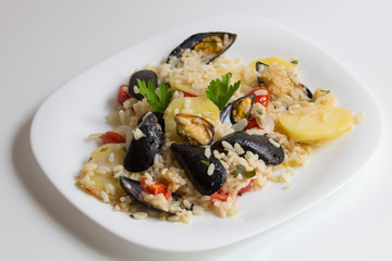 traditional apulian dish rice, potatoes and mussels, Bari cuisine Apulia, close up, on the white plate