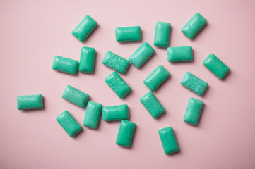 closeup of peppermint chewing gum group on pink background