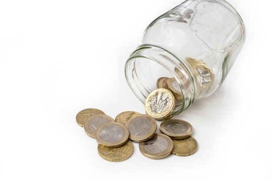 UK money falling from jar, changing ito euro coins