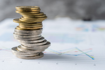Coins are placed on business reports, business concepts and finance.