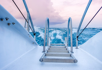 Close up of a part of a Catamaran sailing on the Caribbean Sea by Grand Cayman at sunset