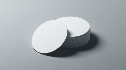Blank white round beer coasters stack mockup on textured surface