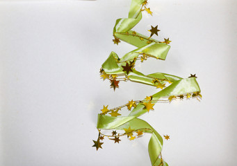 Green glitter ribbon in shape of Christmas tree on white background.  Copyspace for text, congratulations, invitation.