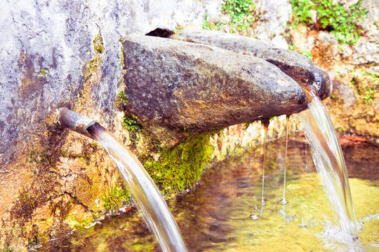 Stone source of drinking water comes from a mountain - image with copy space