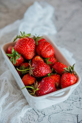 A Cup with fresh ripe strawberries.