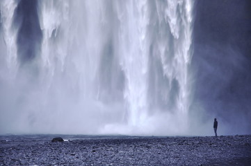 waterfall Skógafoss and man 