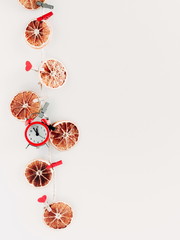 Christmas composition. Garland made of dried orange, lemon on white background. Christmas, New Year, winter concept. Flat lay, top view, copy space 