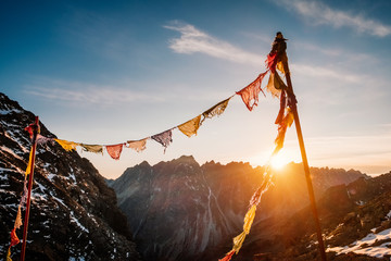 Praying flags in Rysy mountain at sunset