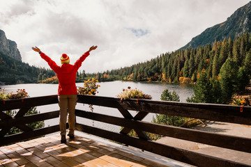 Woman on terrace with mountain lake view