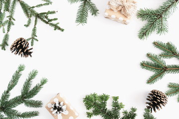Christmas minimal composition. Coniferous tree branches, gift, cones on white background....
