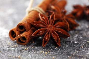 cinnamon and staranise winter spices on rustic background