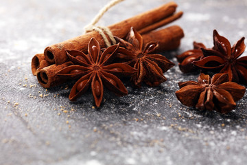 cinnamon and staranise winter spices on rustic background