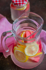 Lemonade watermelon and lemon in a glass carafe. The concept of a refreshing drink in the summer.