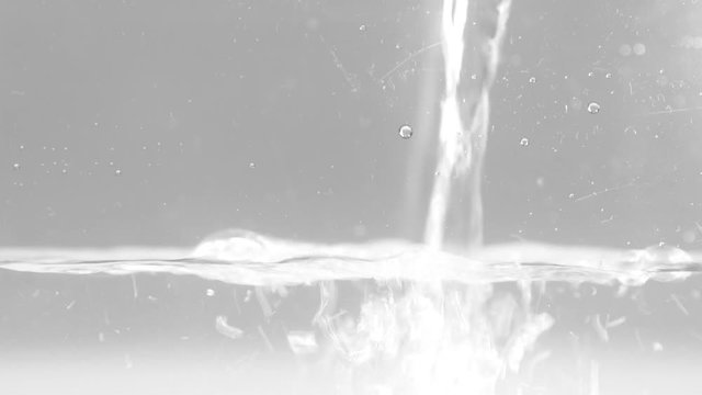 コップへ水を注ぐ様子を真横から撮影した映像。水がたまって徐々に水面が上がってくる様子。