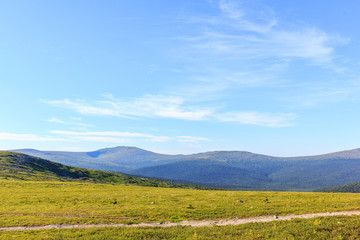 Fototapeta na wymiar Footpath in the mountains. Beautiful panoramic view of the mountains. Northern Ural. Travels.