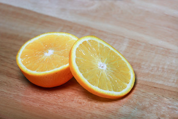 Close up slice of orange on wooden background