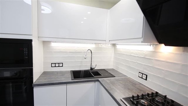  modern kitchen interior and running water from the tap.