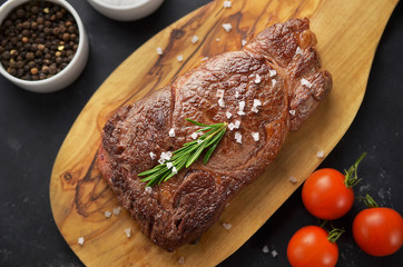 grilled steak with sauce on cutting board