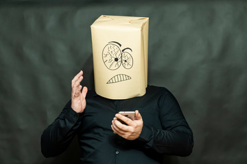 Emotion concept. A man looks into mobile phone. The right hand is raised. Facial expression of...