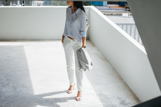 Unrecognisable elegant woman wearing pumps standing outdoors.