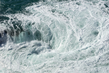 Fototapeta na wymiar Sea water splash with foamy wave. Water surface texture