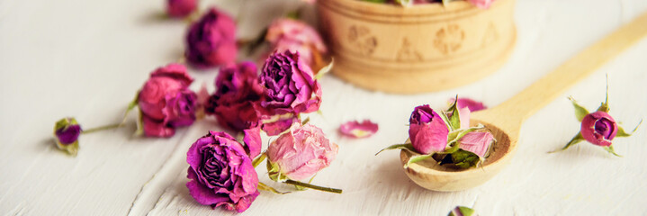 pink buds in a glass jar on a white background