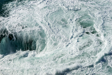 Sea water splash with foamy wave. Water surface texture