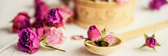 pink buds in a glass jar on a white background