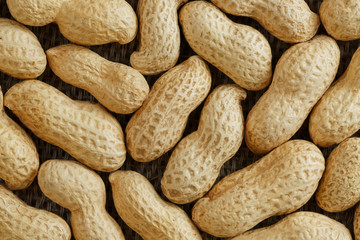 Peanuts in their shell textured food background.