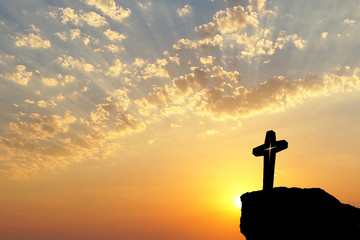 Silhouette of Jesus christ crucifix on cross over sunset.Concept for Catholic religion, Christian worship, Christmas, Easter Day, Bible,Thanksgiving prayer and praise good Friday.