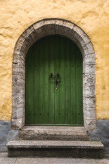 Fototapeta na wymiar Green door in house at old town